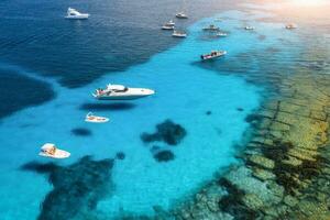 Aerial view of luxury yachts on blue sea at sunset in summer photo