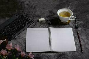 high angle desk with hot tea keyboard photo