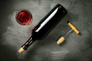 Red wine bottle on a wooden background photo