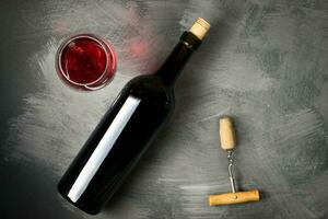 Red wine bottle on a wooden background photo