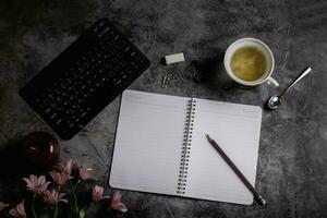 high angle desk with hot tea keyboard photo