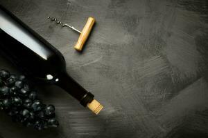 Red wine bottle on a wooden background photo
