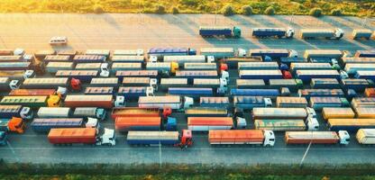 Aerial view of colorful trucks in terminal at sunrise in summer photo