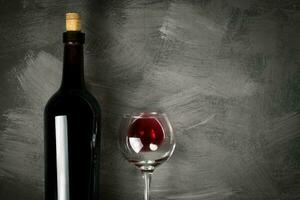 Red wine bottle on a wooden background photo