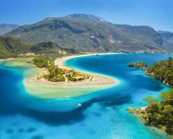 Aerial view of sea bay, sandy beach, green trees, mountain photo