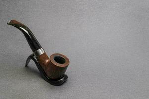 Smoking tobacco pipe bent type wooden. Briar photo