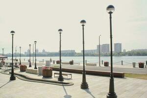 Embankment in river station pier. Starting point of cruise tourism ships. Passenger terminal. Pedestrian park photo