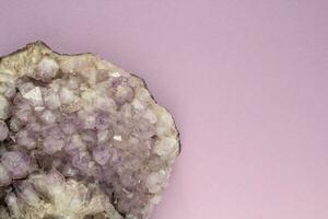 Natural violet amethyst druse geode mineral crystal polished semi-precious gemstone on purple background. Magic rock for witchcraft, spiritual practice, meditation. Esoteric life balance concept photo