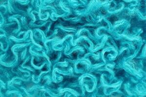 Close-up of colourful merino wool deep blue striped background. Abstract handmade craft knitting yarn textured pattern flatlay. Holiday christmas concept. Idea for felting, needlework, hobby. Mock up photo