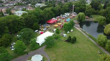 High Angle Footage of Public Funfair Held at Wardown Public Park of Luton with Free Access for Muslim Community on Islamic Holy Eid Festival Day. Captured with Drone's Camera on July 2nd, 2023 video