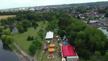 High Angle Footage of Public Funfair Held at Wardown Public Park of Luton with Free Access for Muslim Community on Islamic Holy Eid Festival Day. Captured with Drone's Camera on July 2nd, 2023 video