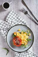 Bruschetta with scrambled egg, arugula, tomato and sesame on a plate top and vertical view photo