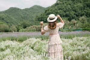 Young woman with bouquet in lavender field photo