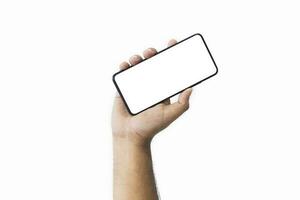 Male hand holding black smartphone with blank screen and modern frameless design two positions angled copy space isolated on white background. close-up hand of man hold mobile phone. Space for text. photo