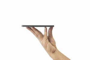 Male hand holding black smartphone with blank screen and modern frameless design two positions angled copy space isolated on white background. close-up hand of man hold mobile phone. Space for text. photo
