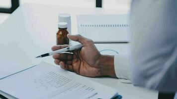Group of healthcare workers and businessman using laptop while having a meeting in the office. Focus is on young doctor. video