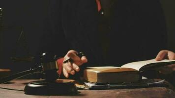 Justice and law concept.Male judge in a courtroom with the gavel, working with, computer and docking keyboard, eyeglasses, on table in morning light video