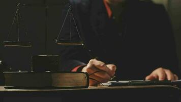 Justice and law concept.Male judge in a courtroom with the gavel, working with, computer and docking keyboard, eyeglasses, on table in morning light video