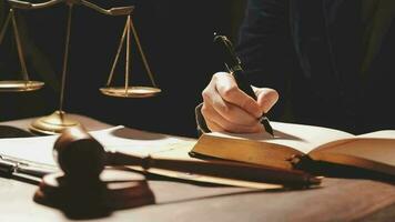 Justice and law concept.Male judge in a courtroom with the gavel, working with, computer and docking keyboard, eyeglasses, on table in morning light video