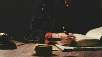 Justice and law concept.Male judge in a courtroom with the gavel, working with, computer and docking keyboard, eyeglasses, on table in morning light video