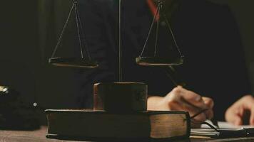 Justice and law concept.Male judge in a courtroom with the gavel, working with, computer and docking keyboard, eyeglasses, on table in morning light video