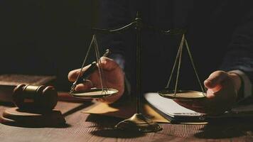 Justice and law concept.Male judge in a courtroom with the gavel, working with, computer and docking keyboard, eyeglasses, on table in morning light video