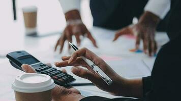 Financial analysts analyze business financial reports on a digital tablet planning investment project during a discussion at a meeting of corporate showing the results of their successful teamwork. video