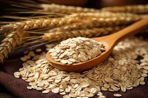 Oatmeal in wooden spoon with ripe oat ears and grains as background. photo