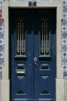 Weathered blue wooden door in Lisbon, Portugal photo