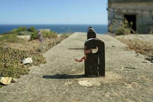 Rusty metal mount near an abandoned coastal building in Portugal photo