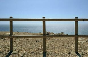 Wooden fence near the coast on a sunny day photo