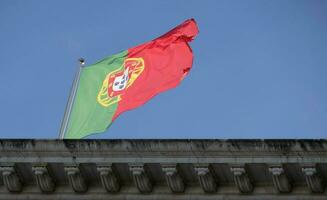 Portuguese flag waving in the wind against a clear sky photo
