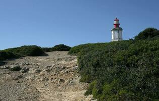 Lighthouse Cabo Espichel at the coast of Portugal on a sunny day photo