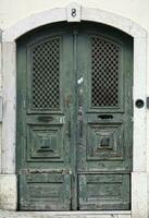 Weathered wooden door in Lisbon, Portugal photo