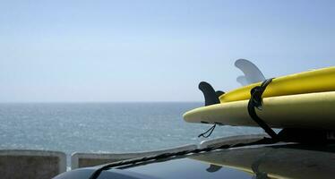 Surfboards loaded onto a car near the coast of Ericeira, Portugal photo