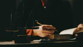 Justice and law concept.Male judge in a courtroom with the gavel, working with, computer and docking keyboard, eyeglasses, on table in morning light video