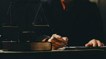 Justice and law concept.Male judge in a courtroom with the gavel, working with, computer and docking keyboard, eyeglasses, on table in morning light video