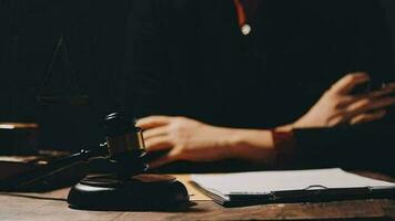 Justice and law concept.Male judge in a courtroom with the gavel, working with, computer and docking keyboard, eyeglasses, on table in morning light video