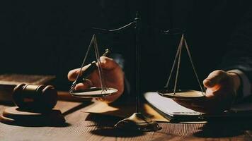 Justice and law concept.Male judge in a courtroom with the gavel, working with, computer and docking keyboard, eyeglasses, on table in morning light video