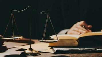 Justice and law concept.Male judge in a courtroom with the gavel, working with, computer and docking keyboard, eyeglasses, on table in morning light video