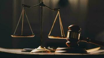 Justice and law concept.Male judge in a courtroom with the gavel, working with, computer and docking keyboard, eyeglasses, on table in morning light video