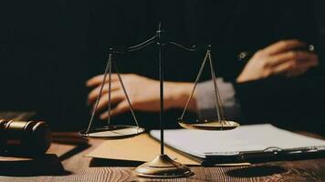 Justice and law concept.Male judge in a courtroom with the gavel, working with, computer and docking keyboard, eyeglasses, on table in morning light video