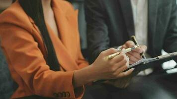 Financial analysts analyze business financial reports on a digital tablet planning investment project during a discussion at a meeting of corporate showing the results of their successful teamwork. video