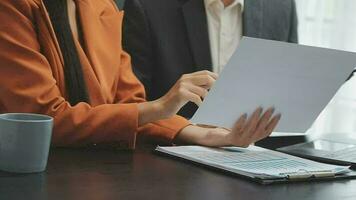 Financial analysts analyze business financial reports on a digital tablet planning investment project during a discussion at a meeting of corporate showing the results of their successful teamwork. video