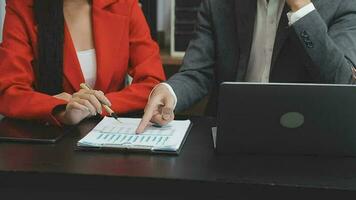 Financial analysts analyze business financial reports on a digital tablet planning investment project during a discussion at a meeting of corporate showing the results of their successful teamwork. video