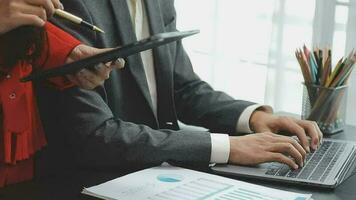 Financial analysts analyze business financial reports on a digital tablet planning investment project during a discussion at a meeting of corporate showing the results of their successful teamwork. video