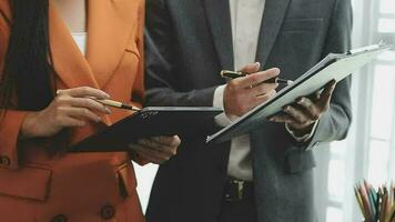 Financial analysts analyze business financial reports on a digital tablet planning investment project during a discussion at a meeting of corporate showing the results of their successful teamwork. video