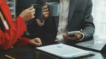 Financial analysts analyze business financial reports on a digital tablet planning investment project during a discussion at a meeting of corporate showing the results of their successful teamwork. video