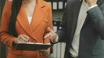 Financial analysts analyze business financial reports on a digital tablet planning investment project during a discussion at a meeting of corporate showing the results of their successful teamwork. video