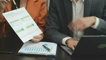 Financial analysts analyze business financial reports on a digital tablet planning investment project during a discussion at a meeting of corporate showing the results of their successful teamwork. video